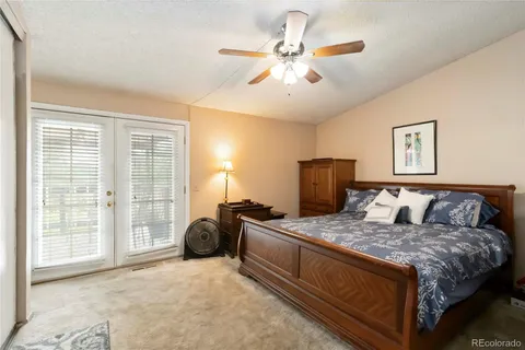 a bedroom with a large bed and a chandelier