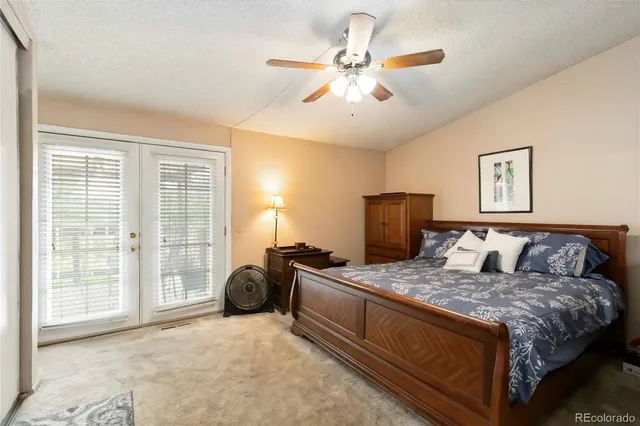 a bedroom with a large bed and a chandelier