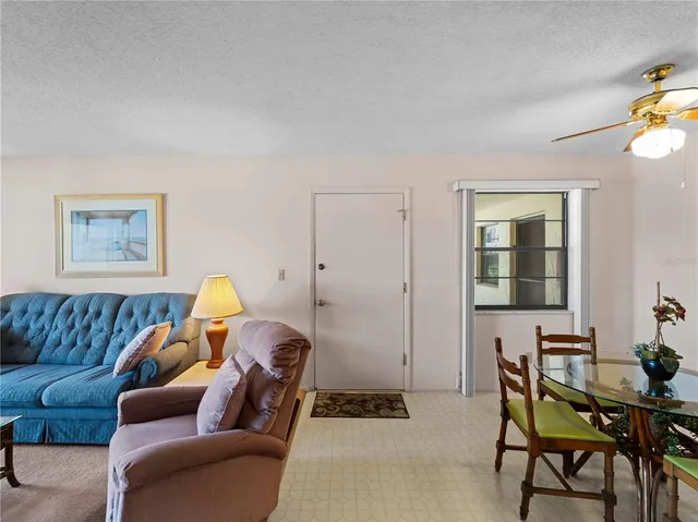 a dining room with furniture and potted plants