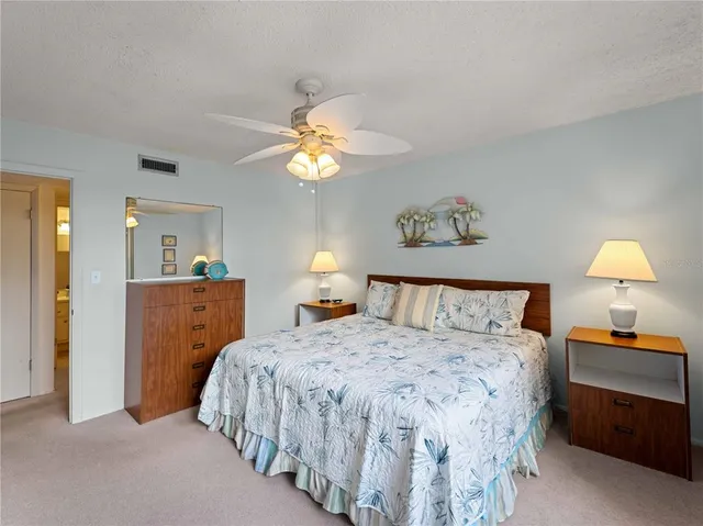 a kitchen with a sink a stove a refrigerator and white cabinets