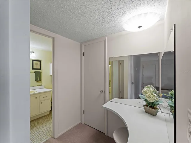 a dining room with furniture and a floor to ceiling window