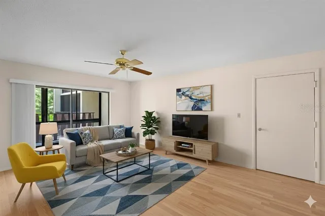 a living room with furniture a window and a chandelier