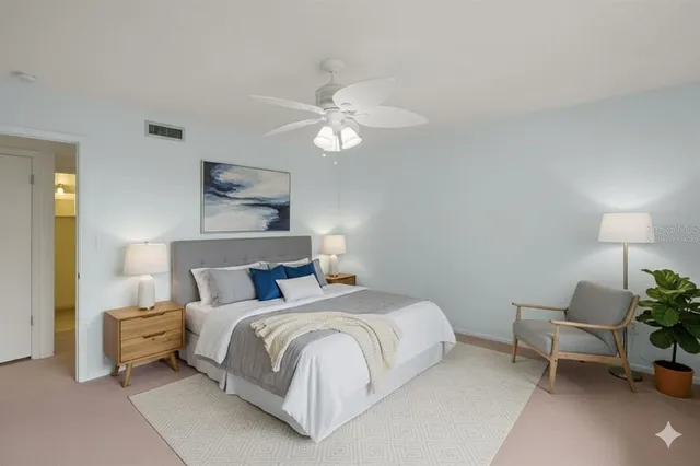 a kitchen with a refrigerator and white cabinets