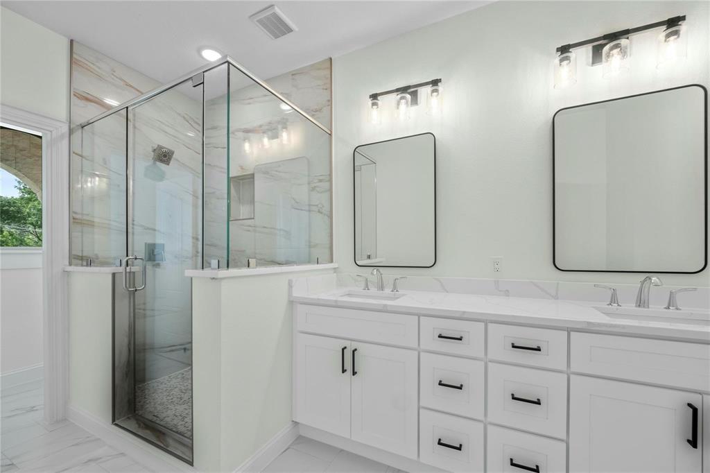 6238 Dewitt Street Sachse, TX 75048 - Photo 13 of 21 a bathroom with double vanity sinks and a shower