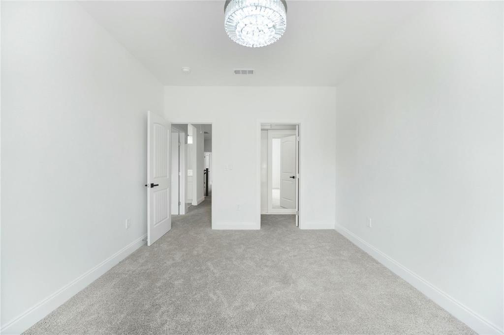 6238 Dewitt Street Sachse, TX 75048 - Photo 18 of 21 a view of a hallway with a chandelier fan