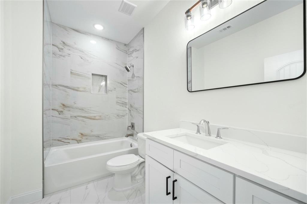 6238 Dewitt Street Sachse, TX 75048 - Photo 19 of 21 a bathroom with a sink a toilet and shower