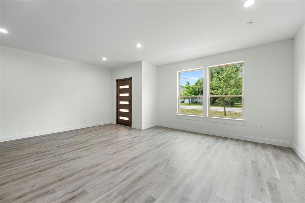 6238 Dewitt Street Sachse, TX 75048 - Photo 2 of 21 a view of an empty room with wooden floor and a window