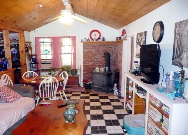 117 Folly Mill Road Salisbury, MA 01952 - Photo 8 of 18 a hall way with furniture a flat screen tv and a fireplace