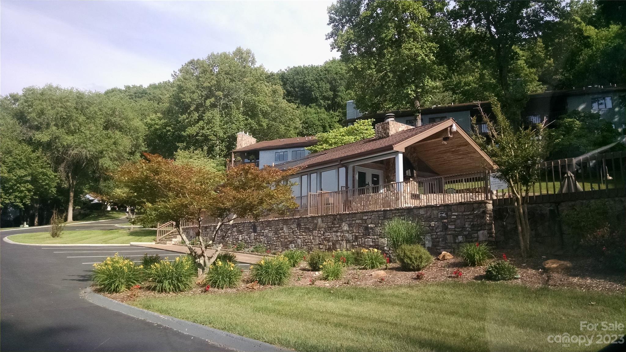 87 Willow Road, Unit D14 Waynesville, NC 28786 - Photo 11 of 47 a backyard of a house with lots of green space and fountain
