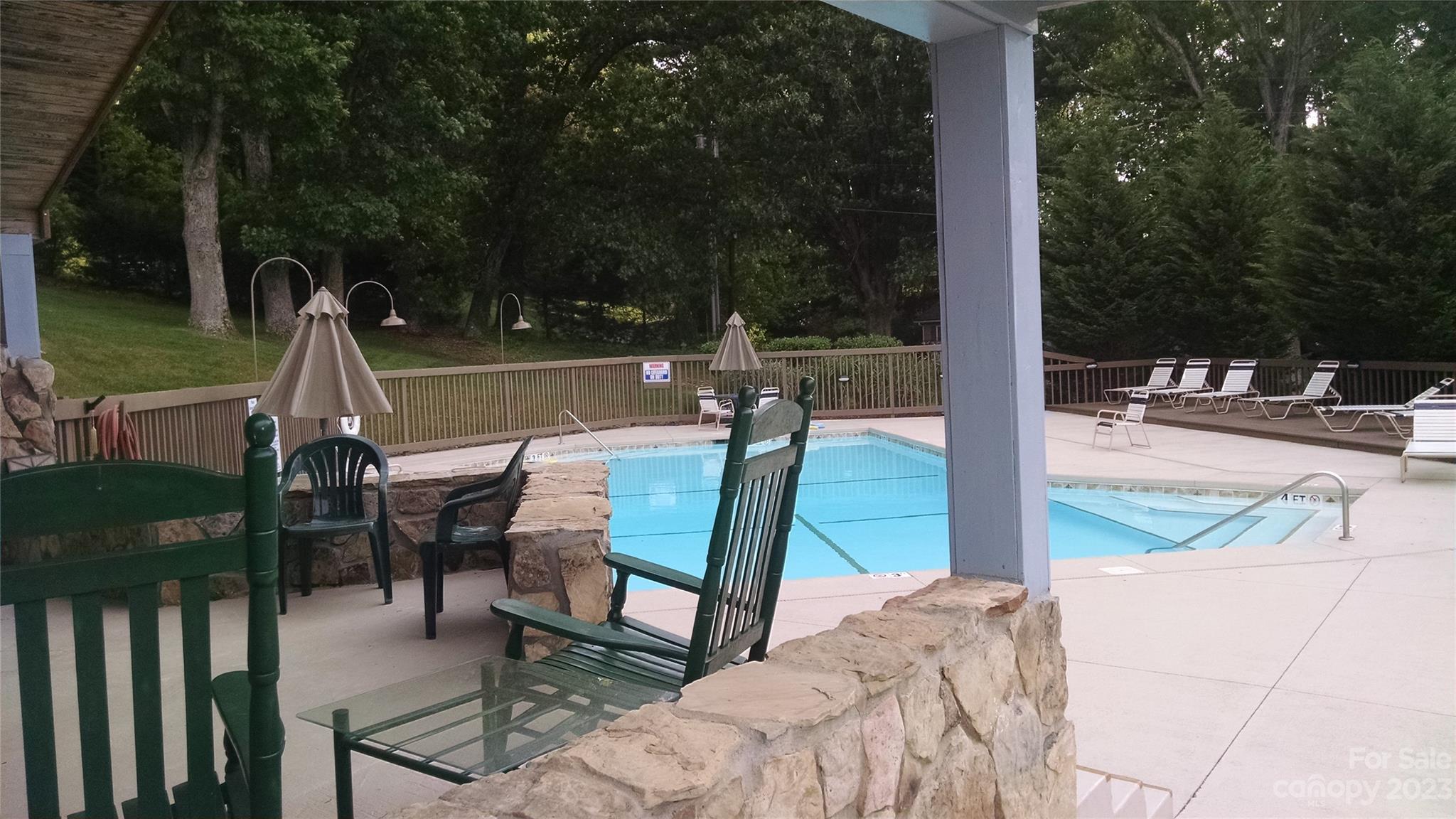 87 Willow Road, Unit D14 Waynesville, NC 28786 - Photo 12 of 47 a view of a patio with a table chairs and a backyard