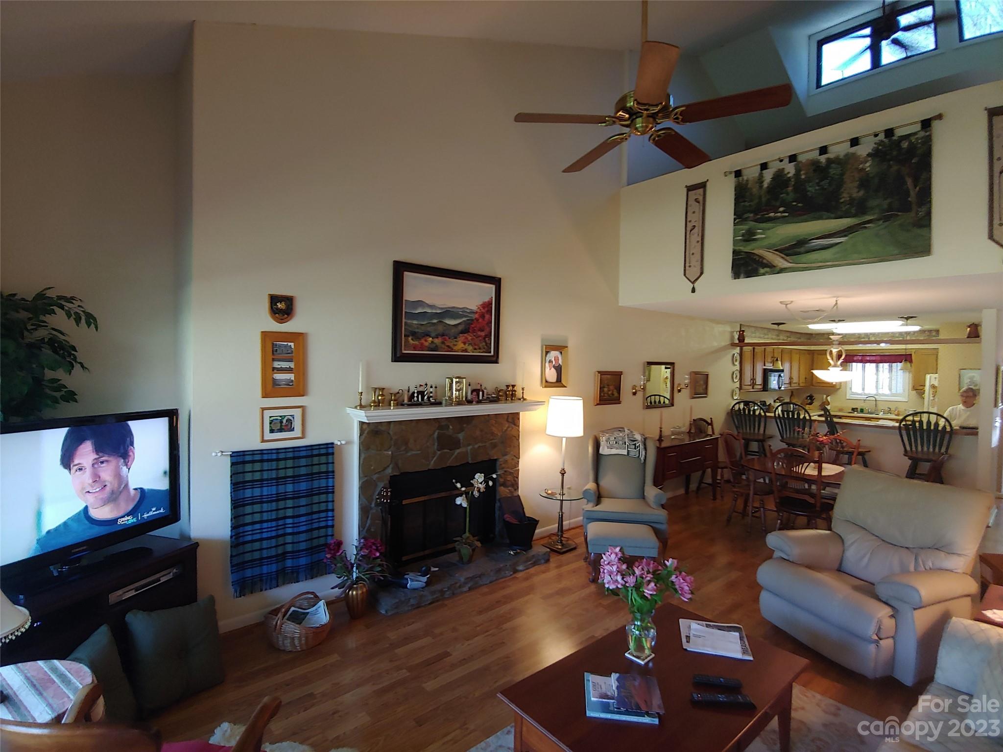 87 Willow Road, Unit D14 Waynesville, NC 28786 - Photo 22 of 47 a living room with furniture a flat screen tv and a fireplace