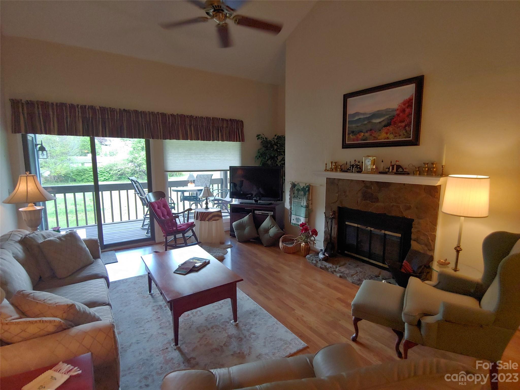 87 Willow Road, Unit D14 Waynesville, NC 28786 - Photo 25 of 47 a living room with furniture fireplace and a large window