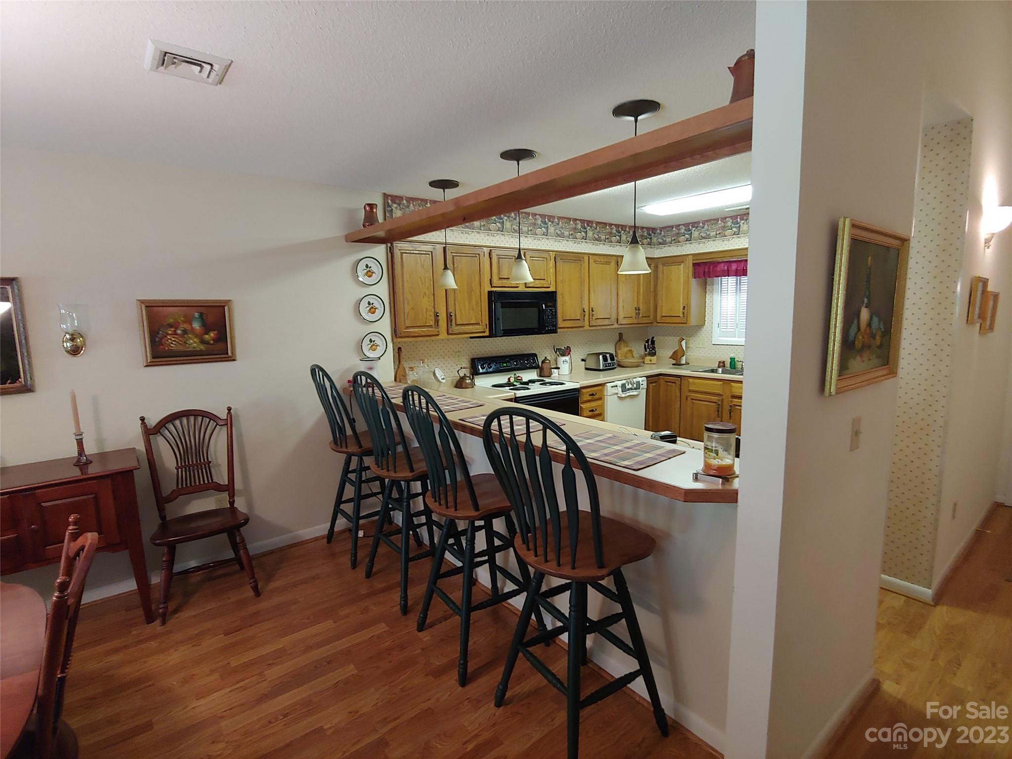 87 Willow Road, Unit D14 Waynesville, NC 28786 - Photo 27 of 47 a view of a dining room with furniture and wooden floor