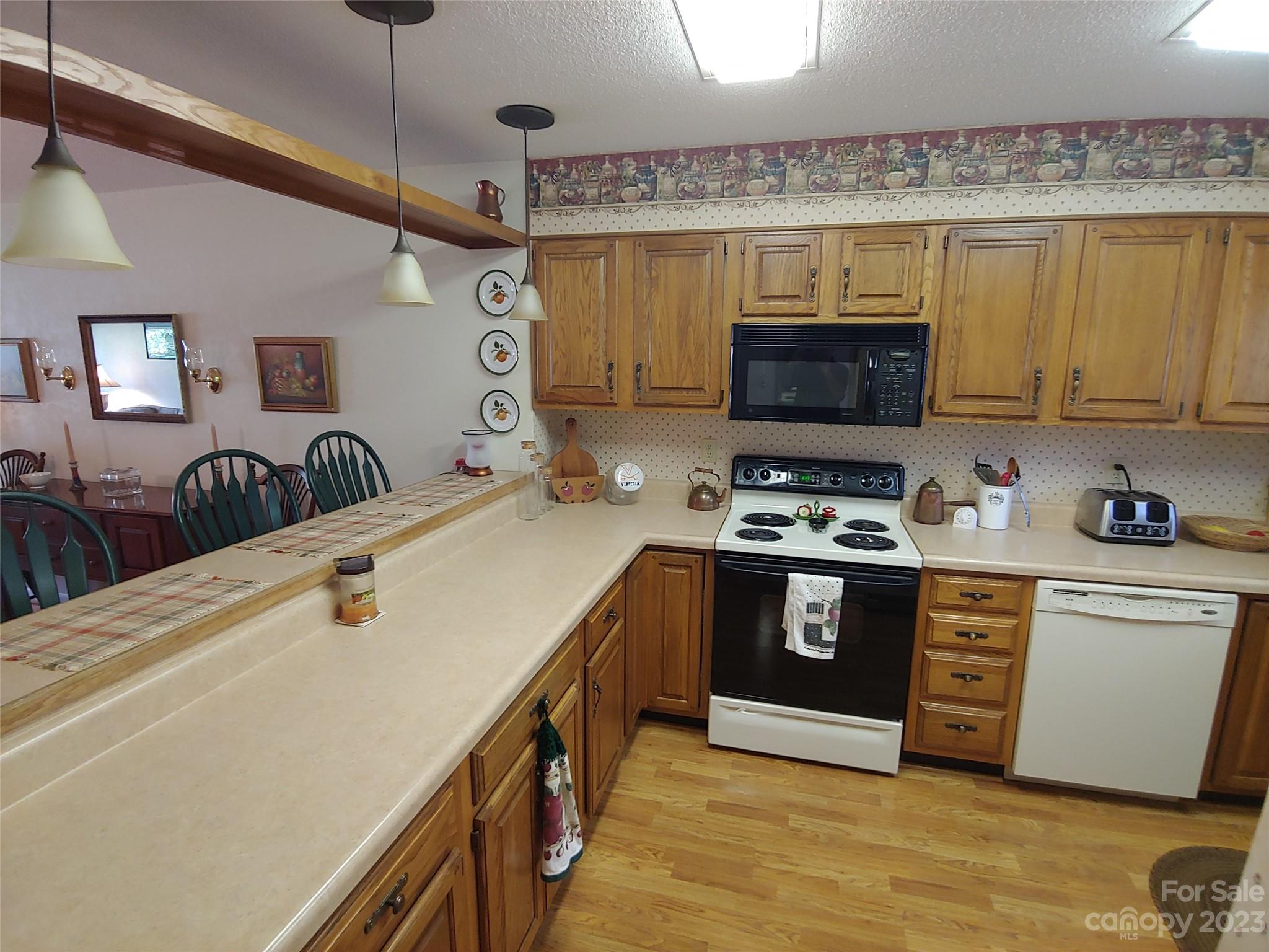 87 Willow Road, Unit D14 Waynesville, NC 28786 - Photo 29 of 47 a kitchen with stainless steel appliances granite countertop a stove and a sink