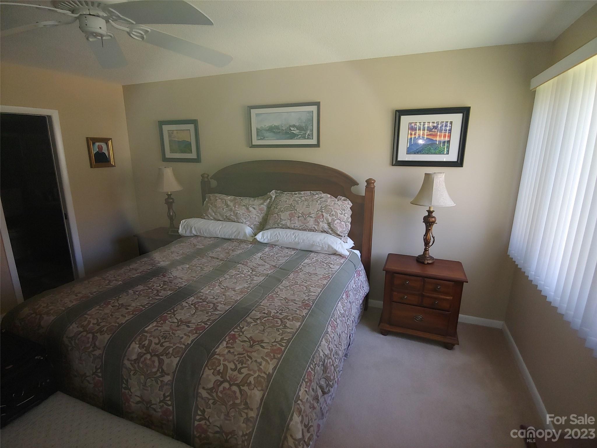 87 Willow Road, Unit D14 Waynesville, NC 28786 - Photo 31 of 47 a bedroom with bed and painting on the wall