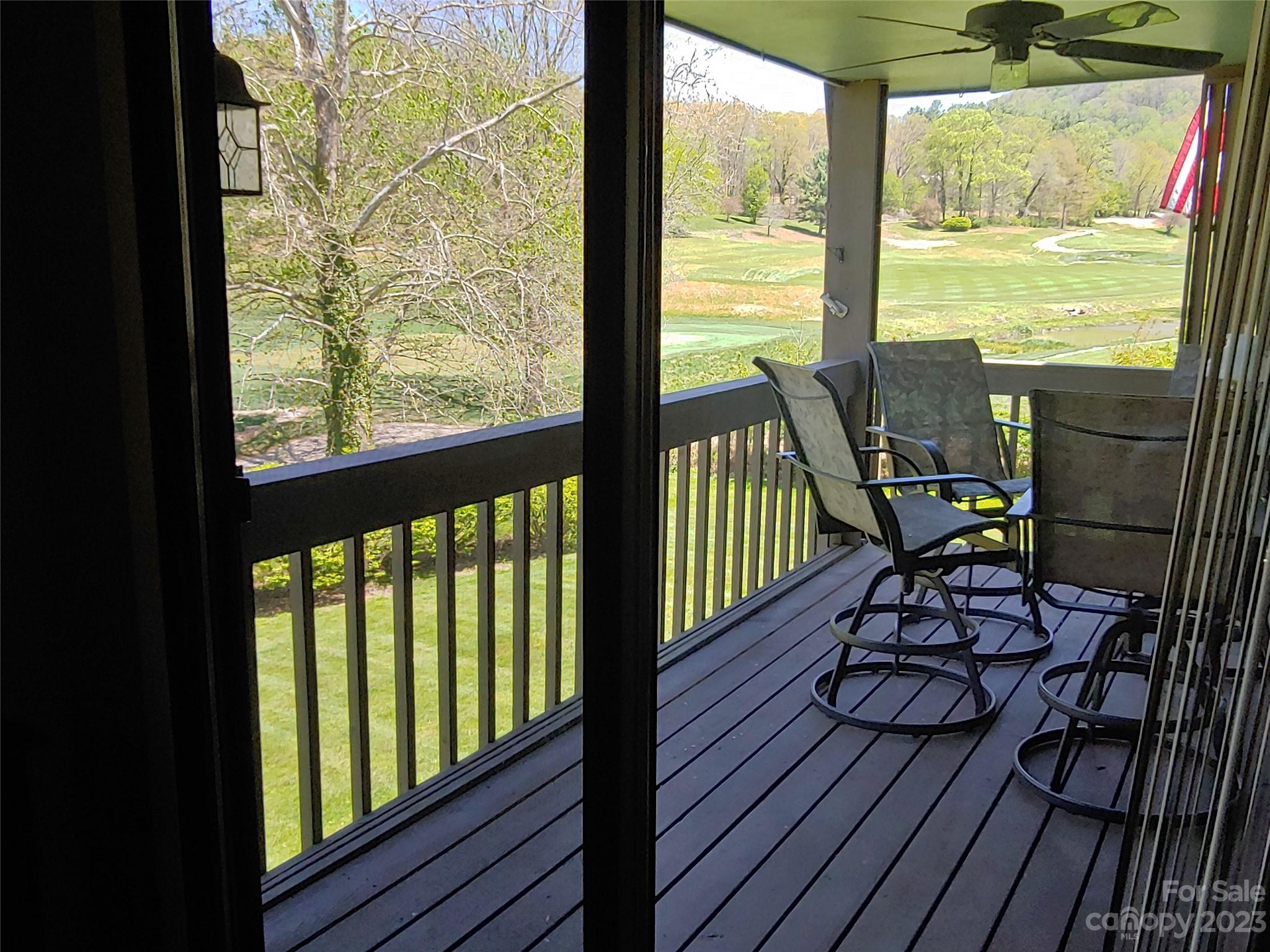 87 Willow Road, Unit D14 Waynesville, NC 28786 - Photo 32 of 47 a view of a balcony with chairs and wooden floor