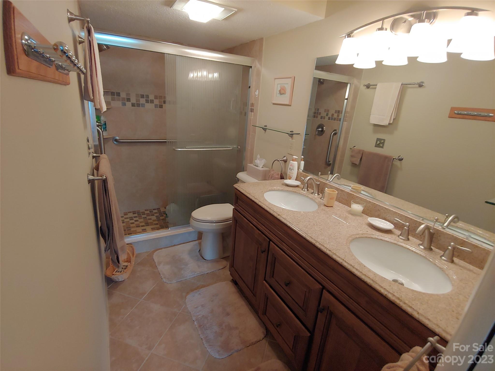 87 Willow Road, Unit D14 Waynesville, NC 28786 - Photo 33 of 47 a bathroom with a sink mirror vanity and toilet