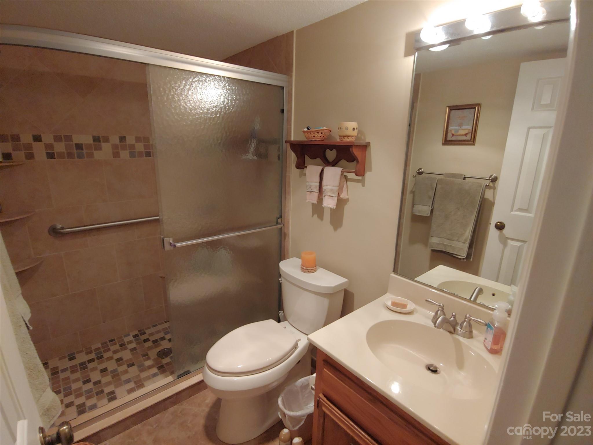 87 Willow Road, Unit D14 Waynesville, NC 28786 - Photo 35 of 47 a bathroom with a sink toilet and shower