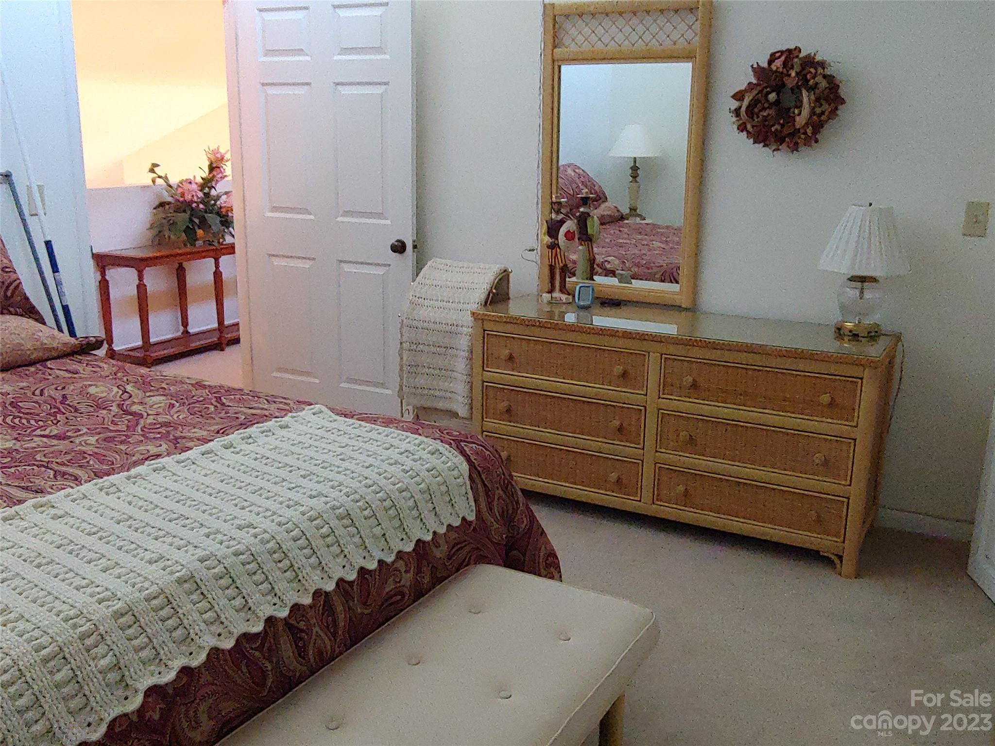 87 Willow Road, Unit D14 Waynesville, NC 28786 - Photo 39 of 47 a bedroom with a bed and a mirror on dresser