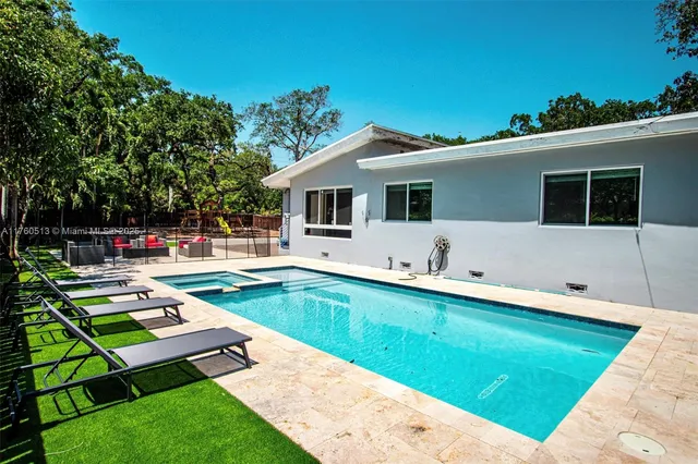 a swimming pool with outdoor seating and yard