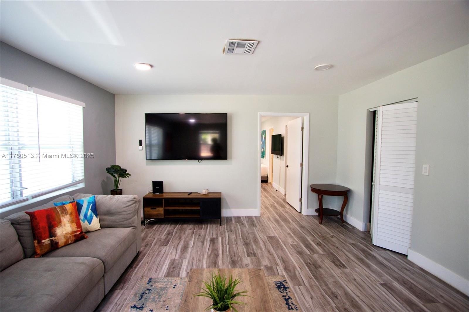 3981 Southwest 58th Street Dania Beach, FL 33312 - Photo 12 of 37 a living room with furniture and a flat screen tv