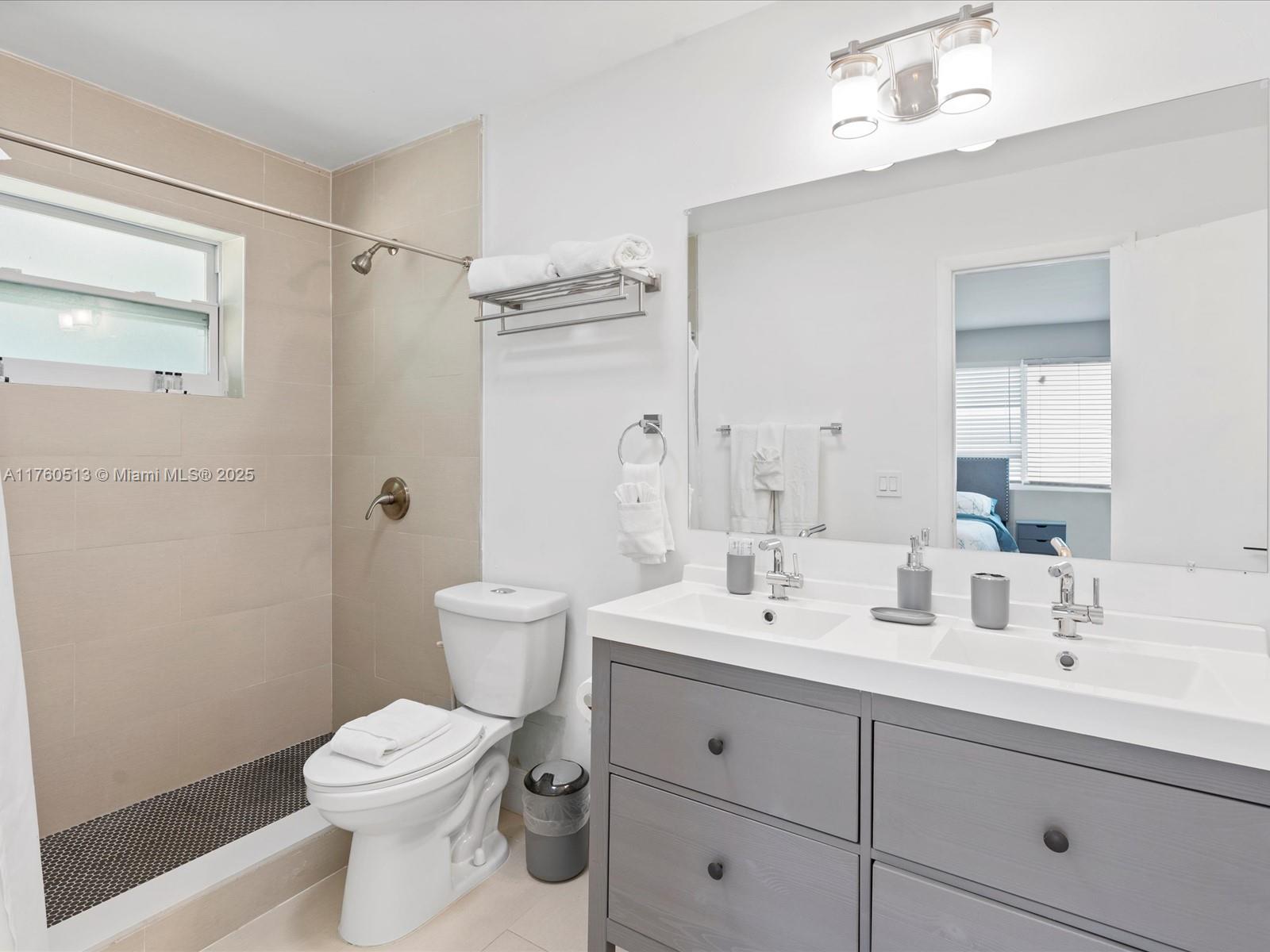 3981 Southwest 58th Street Dania Beach, FL 33312 - Photo 14 of 37 a bathroom with a double vanity sink toilet and shower