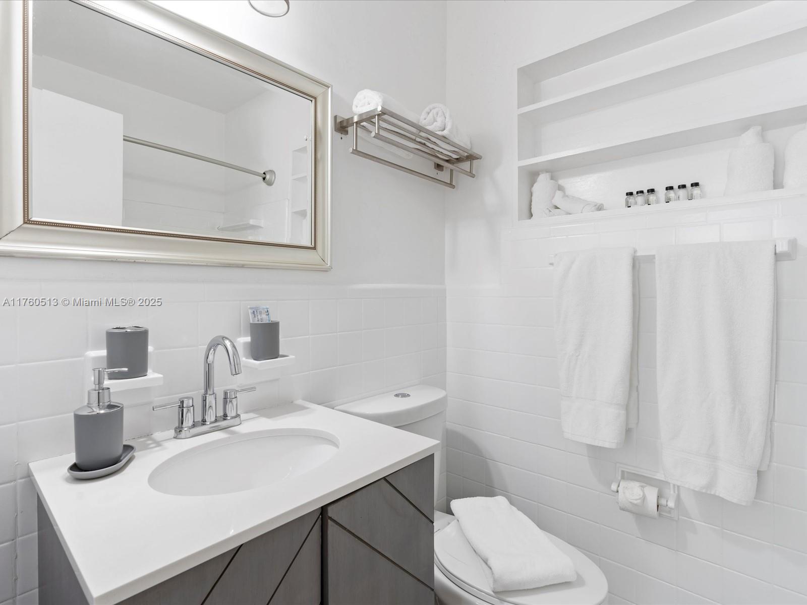 3981 Southwest 58th Street Dania Beach, FL 33312 - Photo 16 of 37 a bathroom with a sink vanity mirror and toilet