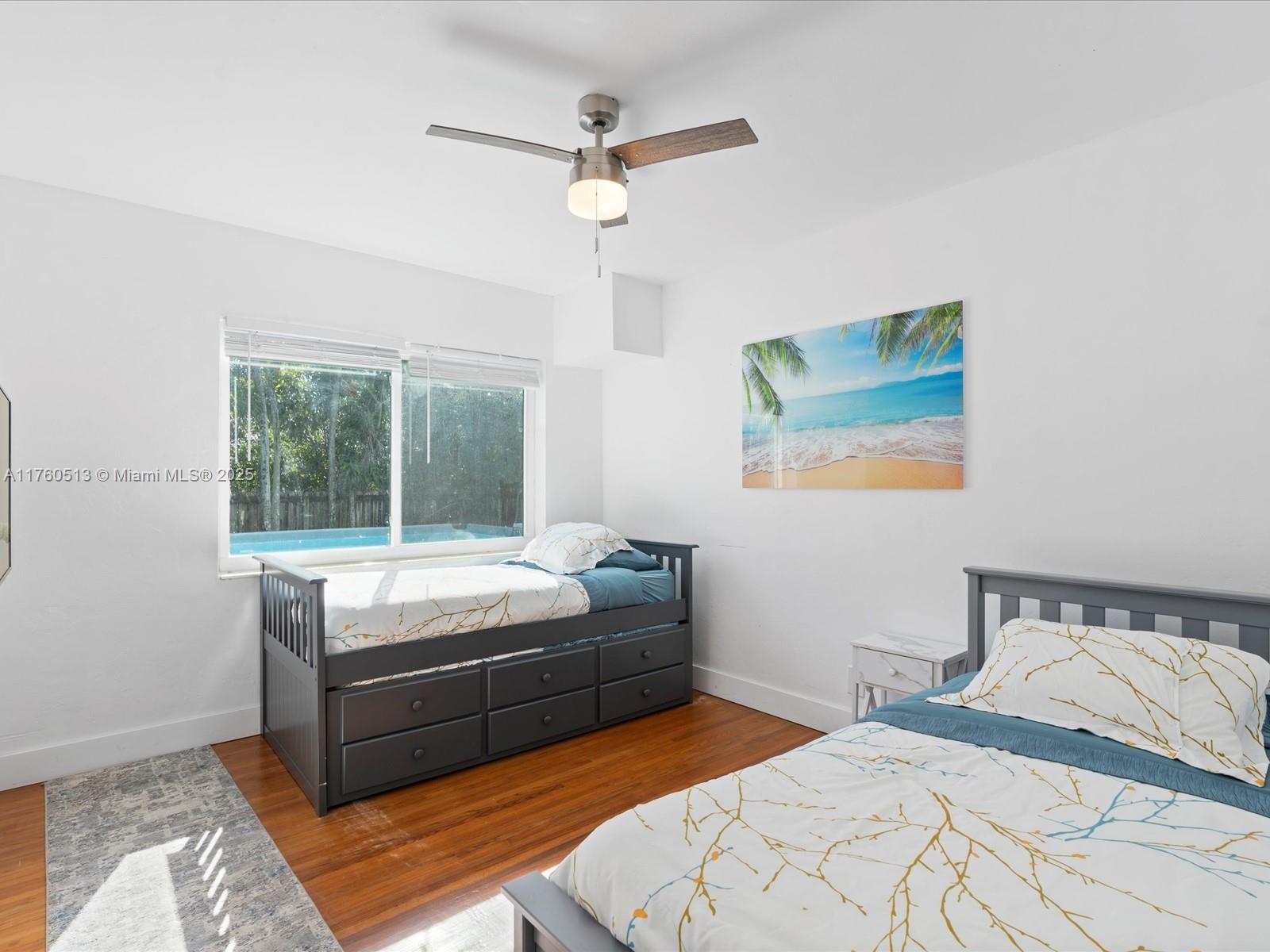 3981 Southwest 58th Street Dania Beach, FL 33312 - Photo 17 of 37 a bedroom with bed and window