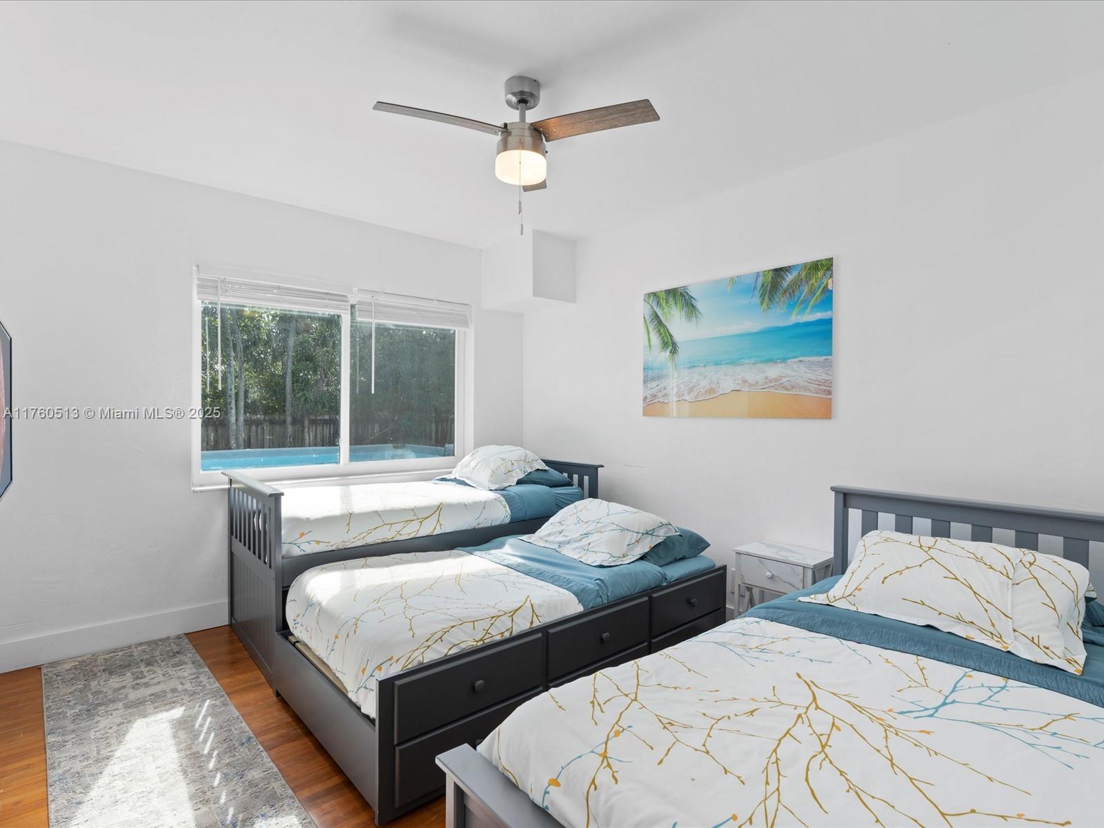 3981 Southwest 58th Street Dania Beach, FL 33312 - Photo 18 of 37 a bedroom with two beds and window