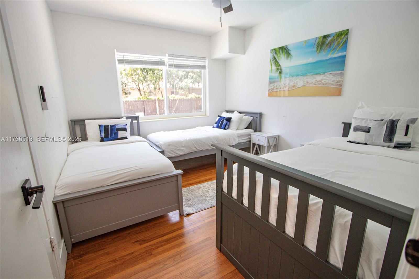 3981 Southwest 58th Street Dania Beach, FL 33312 - Photo 21 of 37 a bedroom with two beds and wooden floor