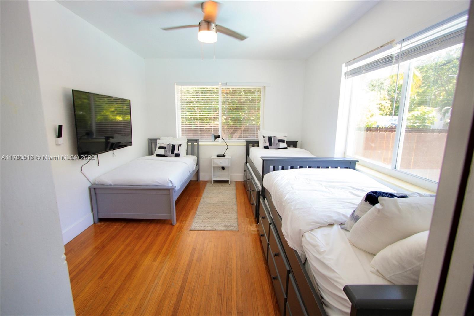 3981 Southwest 58th Street Dania Beach, FL 33312 - Photo 22 of 37 a spacious bedroom with a bed and a flat tv screen on dresser