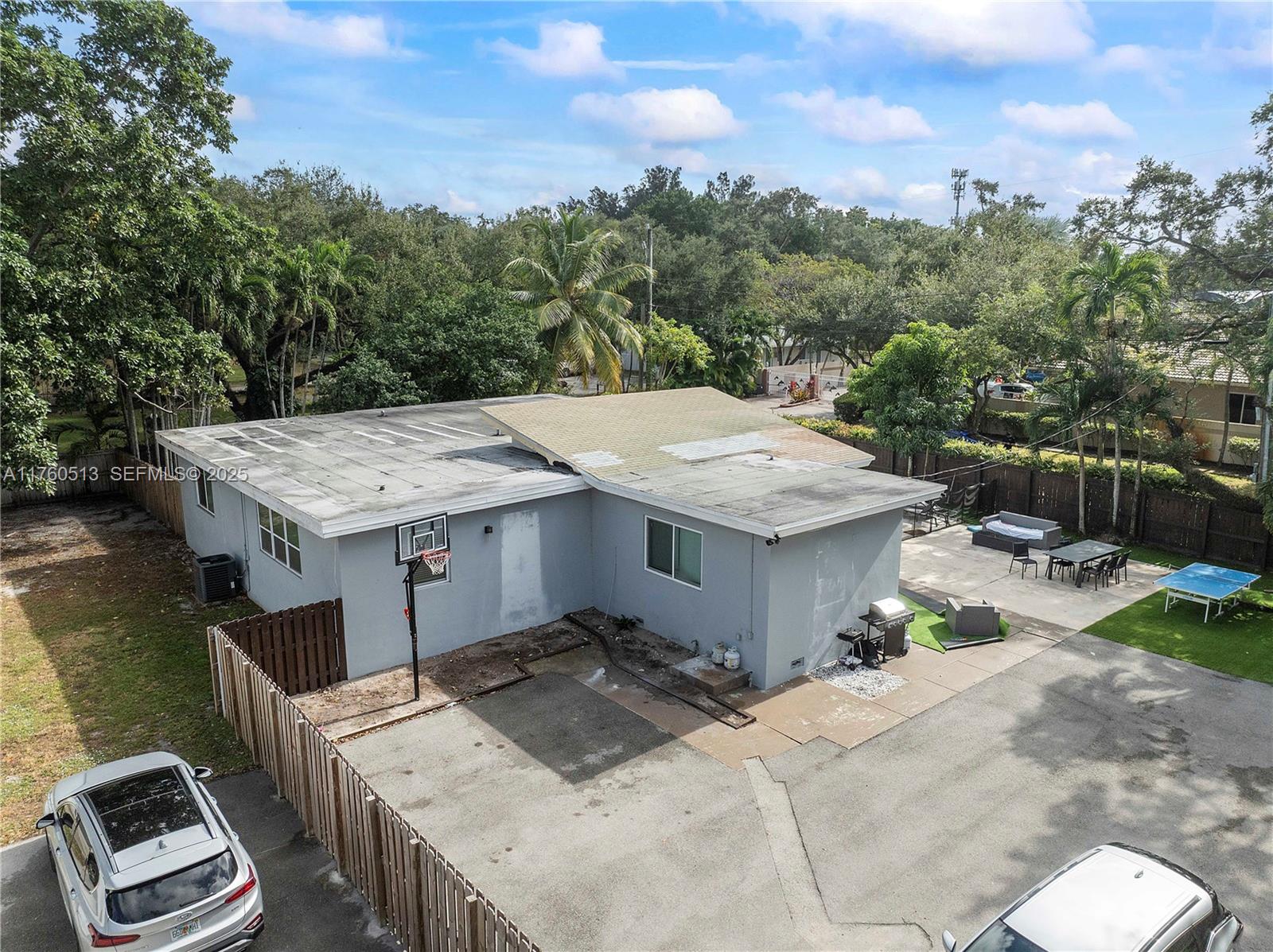 3981 Southwest 58th Street Dania Beach, FL 33312 - Photo 35 of 37 a terrace with a table and chairs