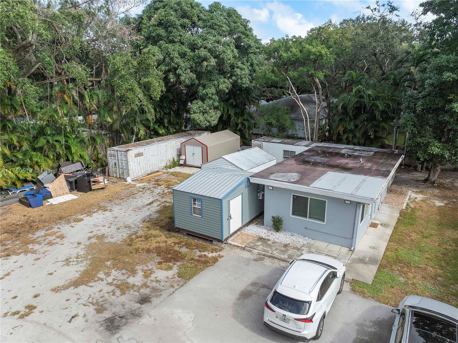 3981 Southwest 58th Street Dania Beach, FL 33312 - Photo 36 of 37 a view of a patio with table and chairs with wooden fence
