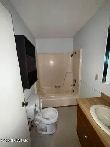 a bathroom with a toilet a sink and bathtub