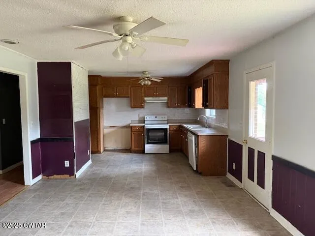 a kitchen with stainless steel appliances granite countertop a stove sink and cabinets