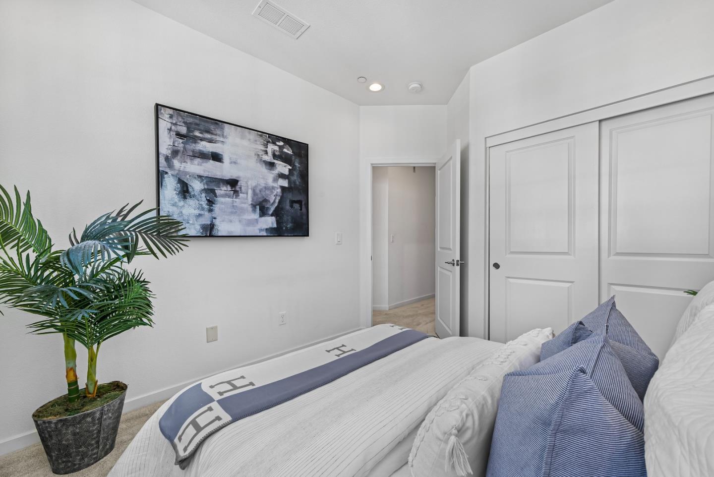 119 Orbit Way Mountain View, CA 94043 - Photo 23 of 46 a bedroom with a bed and a potted plant