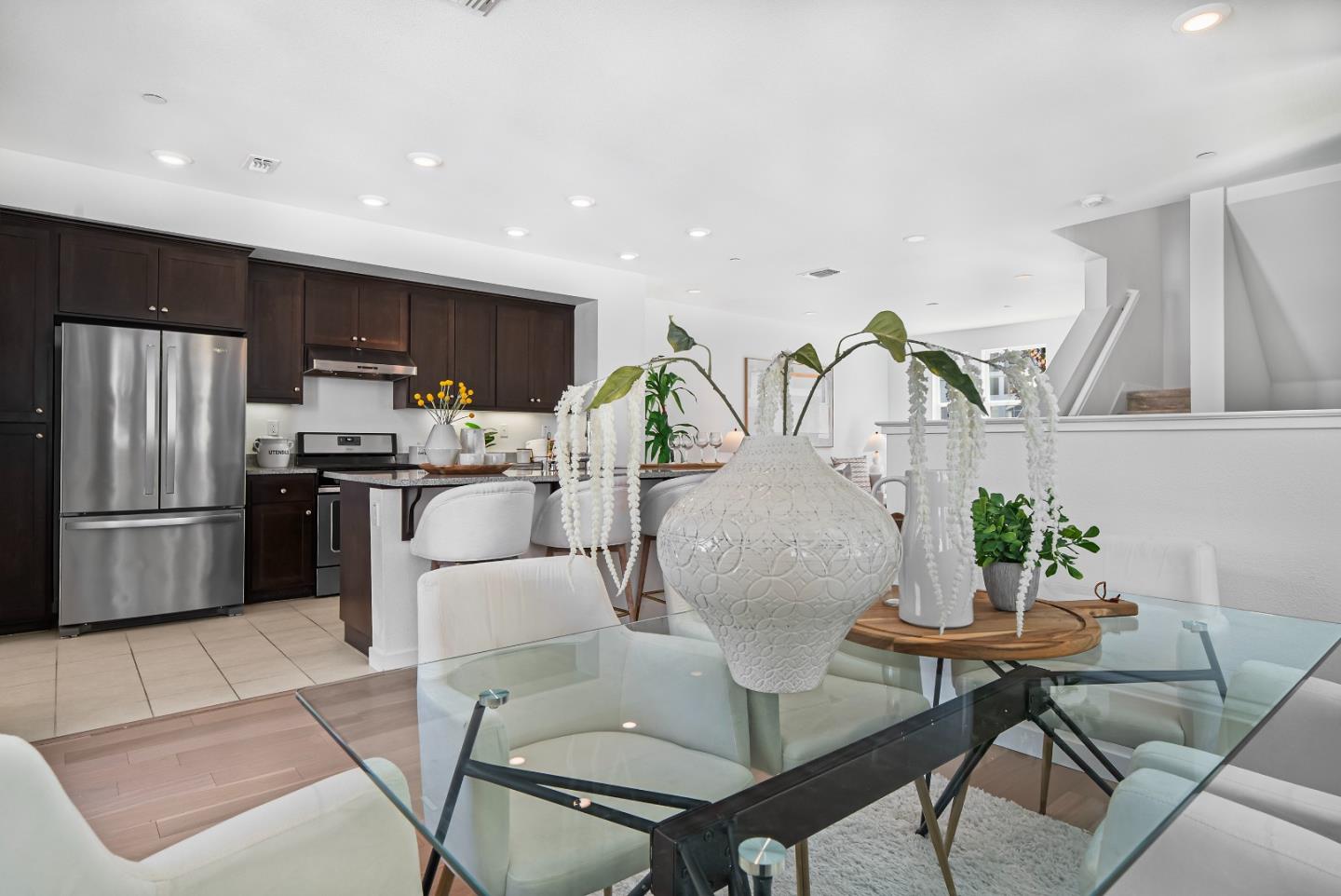 119 Orbit Way Mountain View, CA 94043 - Photo 10 of 46 a kitchen with stainless steel appliances kitchen island granite countertop a refrigerator a stove a sink a dining table and chairs