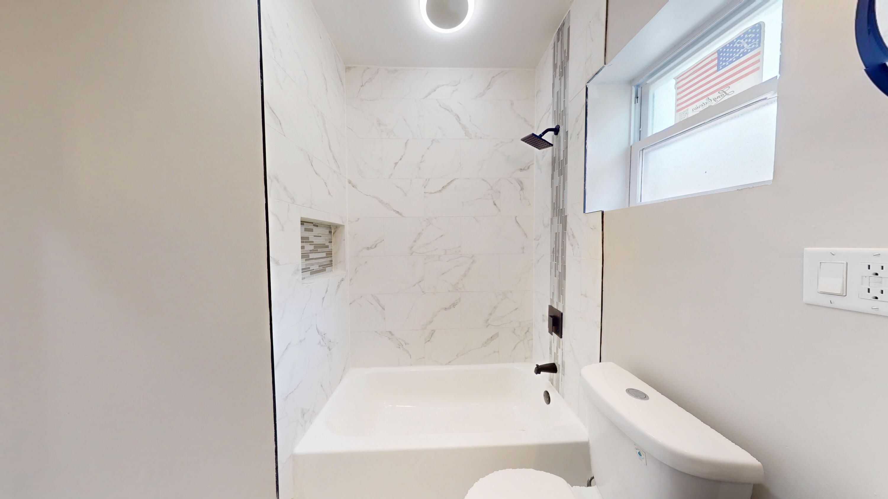 1379 Roosevelt Place Gary, IN 46404 - Photo 14 of 50 a bathroom with a bathtub and a shower