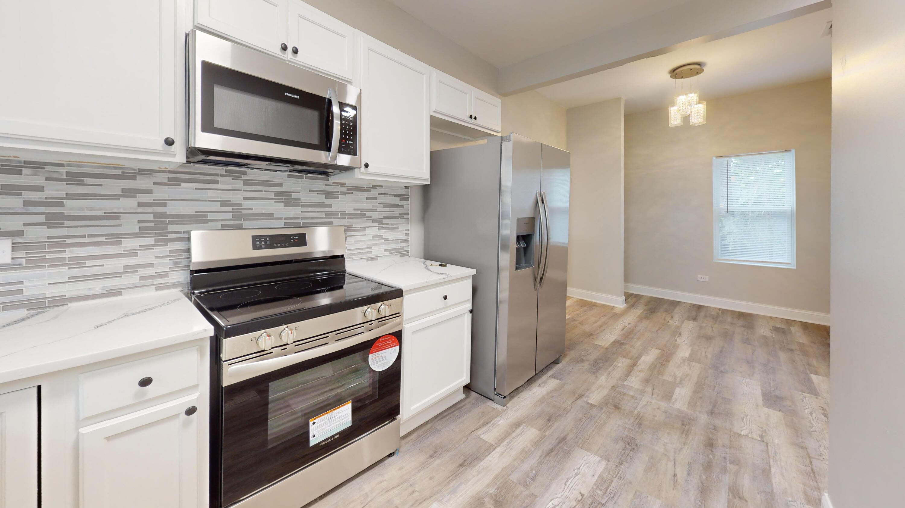 1379 Roosevelt Place Gary, IN 46404 - Photo 21 of 50 a kitchen with a stove microwave and refrigerator