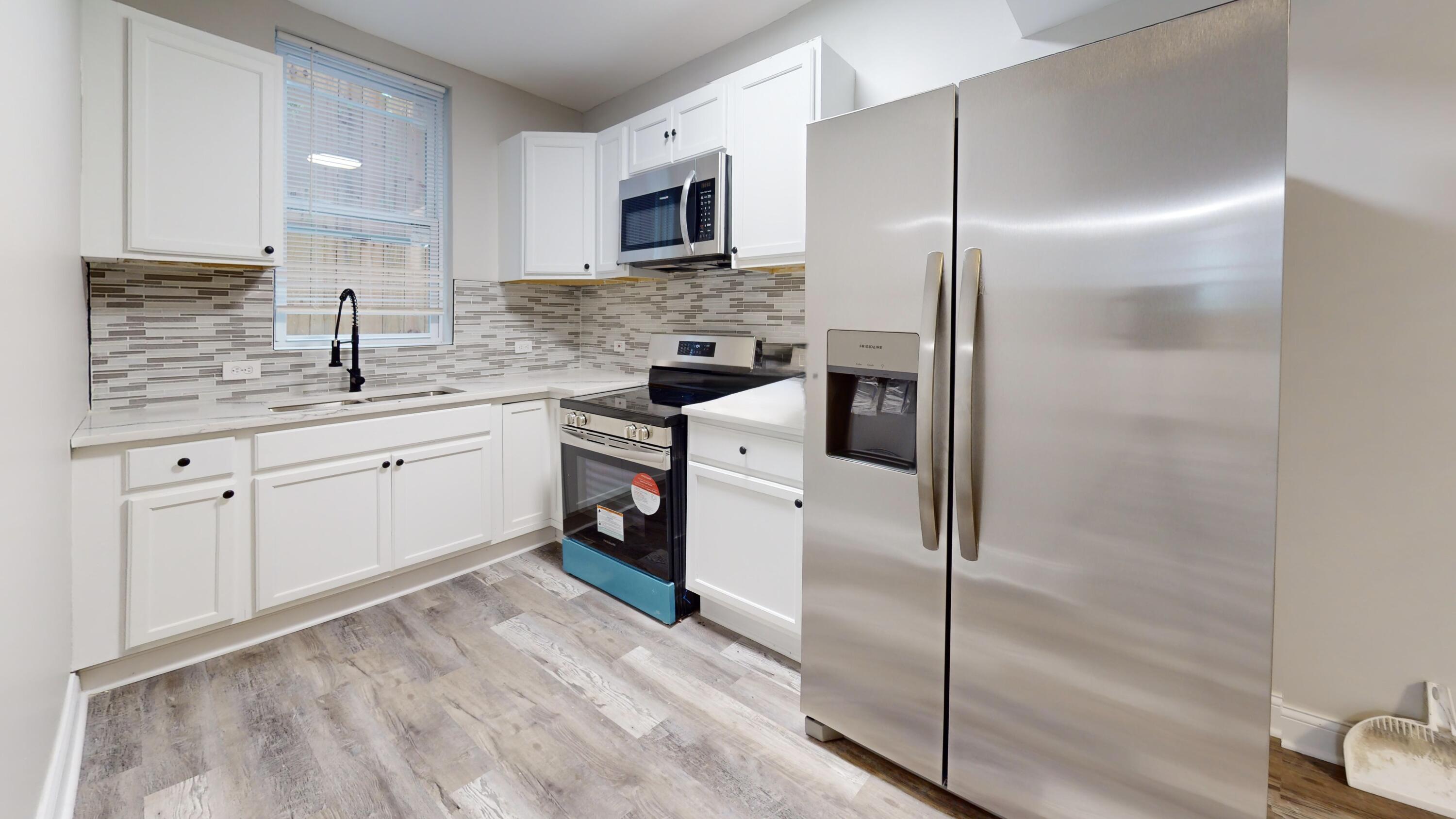 1379 Roosevelt Place Gary, IN 46404 - Photo 40 of 50 a kitchen with white cabinets stainless steel appliances and a sink