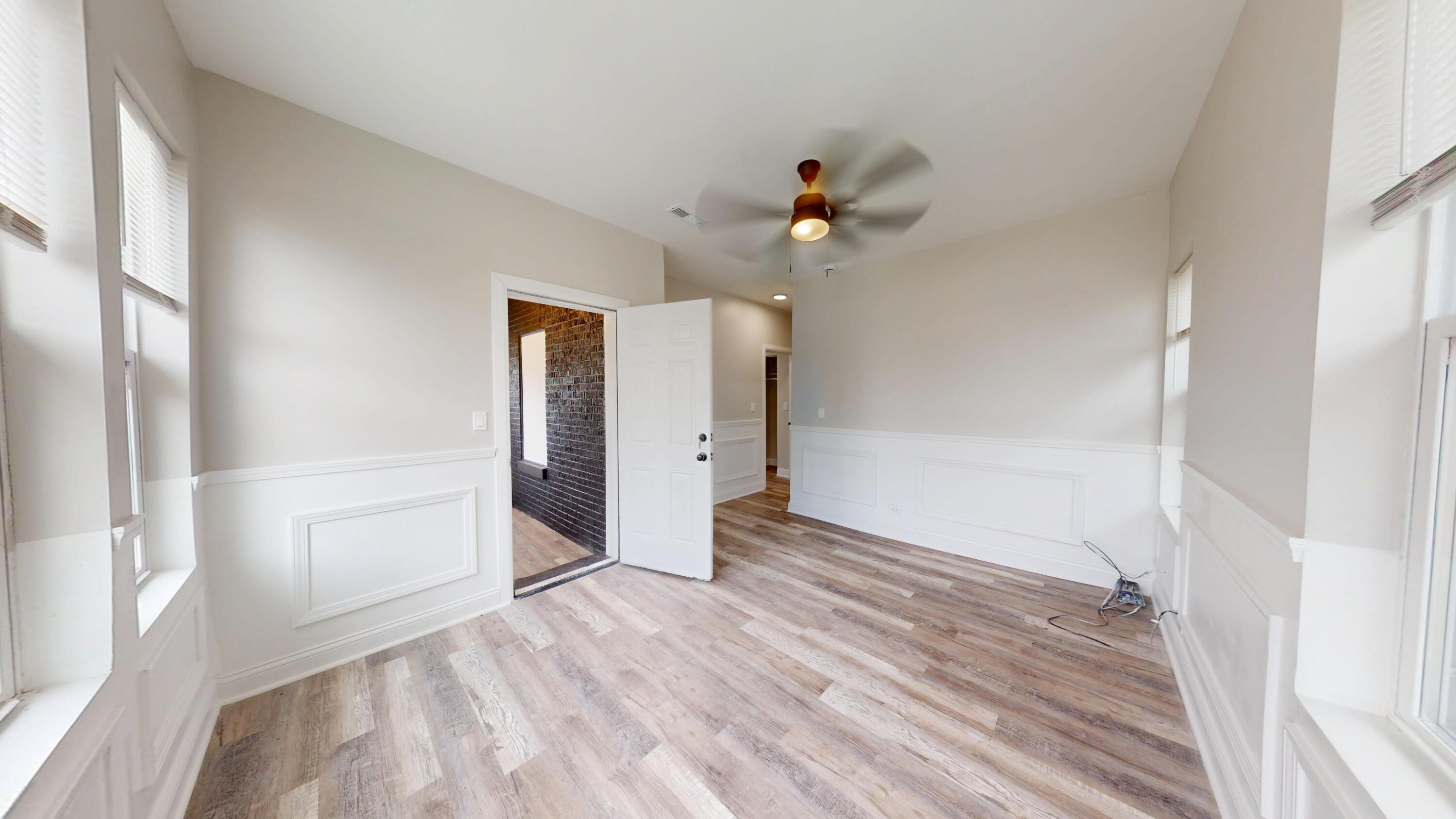 1379 Roosevelt Place Gary, IN 46404 - Photo 7 of 50 a view of empty room with wooden floor and fan