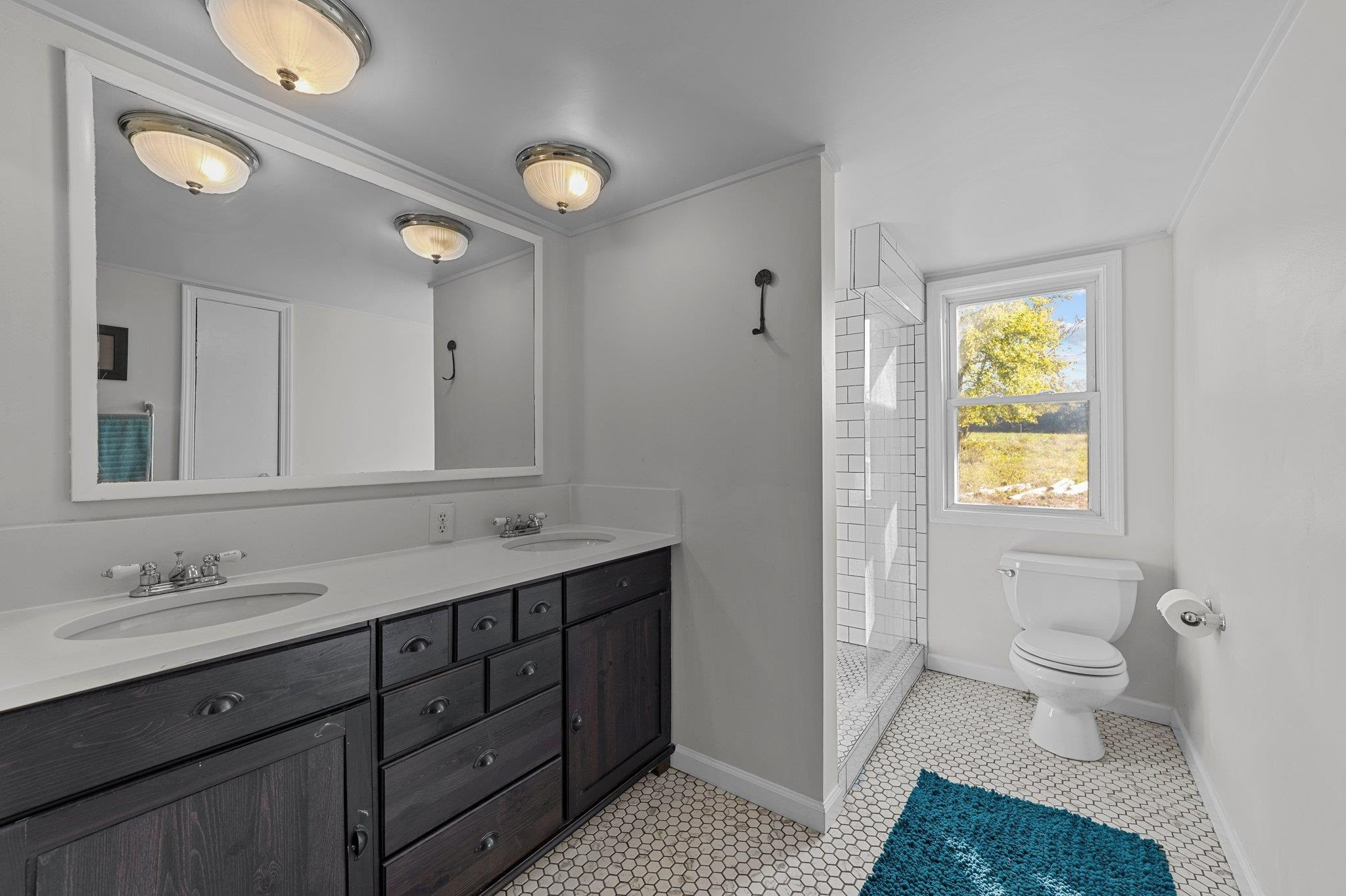 4900 Bahama Road Rougemont, NC 27572 - Photo 16 of 30 a spacious bathroom with a granite countertop sink toilet and shower