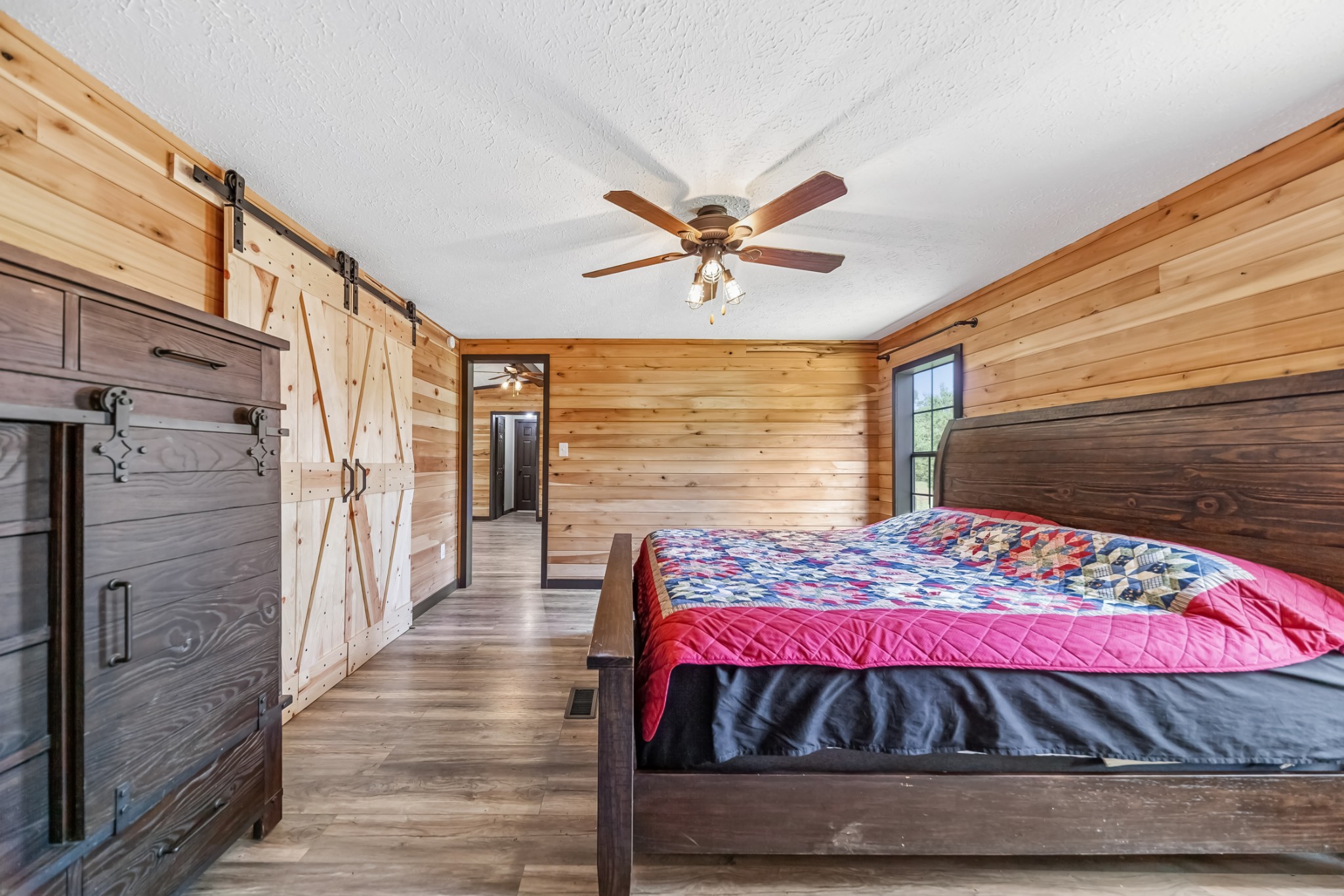 915 Maddox Road Centerville, TN 37033 - Photo 31 of 90 a view of a bedroom with wooden floor and a ceiling fan