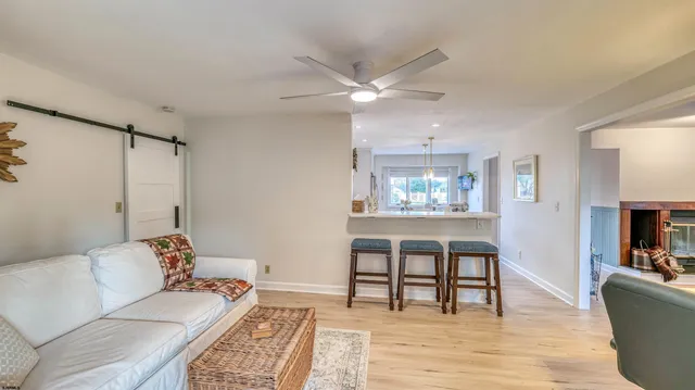 a living room with furniture and a wooden floor