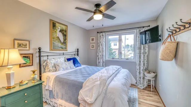 a bedroom with a large bed a chandelier and closet
