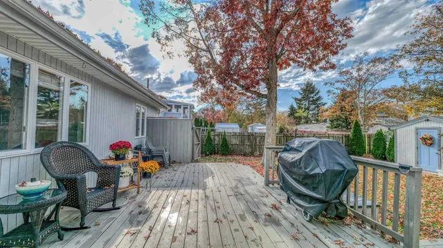 a view of a porch with furniture and floor to ceiling window