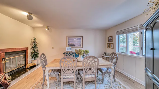a dining room with furniture a flat screen tv and a large window