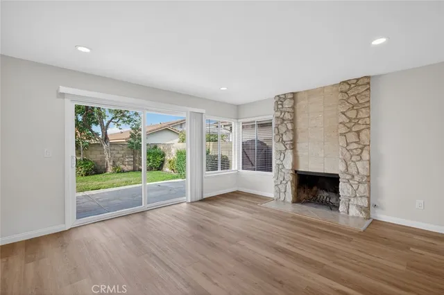 wooden floor fireplace and natural light in room