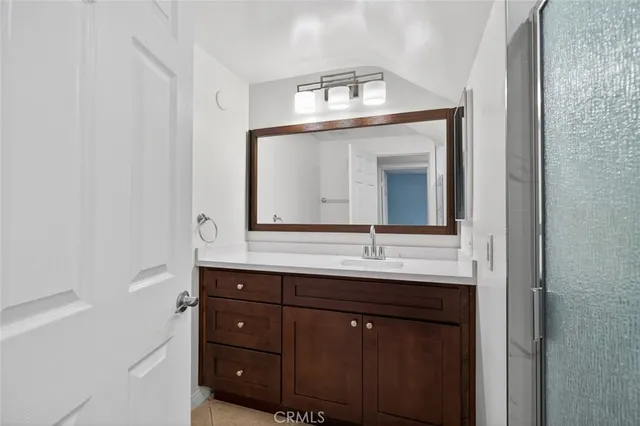 a bathroom with a granite countertop sink a large mirror and a
