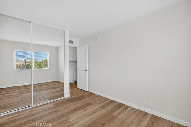 a view of wooden floor and an entryway in a room